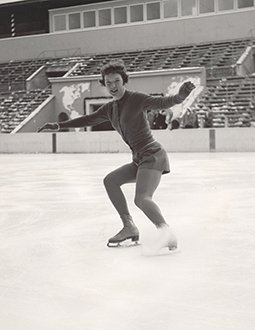 Tenley Albright skates towards the camera while smiling at the Olympic Games.