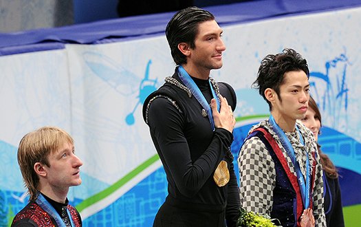 Evan Lysacek stands atop the podium with hand over his heart after winning the gold medal.