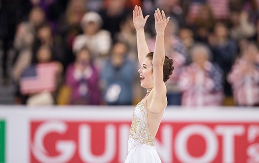 Ashley Wagner smiles and laughs with arms outstretched after the end of her free skate at 2016 World Championships.