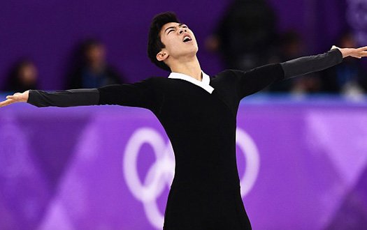 Nathan Chen looks to the sky with his arms outstretched as he completes his free skate.