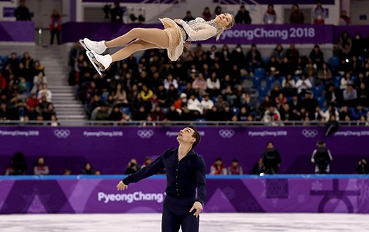 Chris Knierim throws Alexa Knierim into the air for a twist at the Olympic Games.