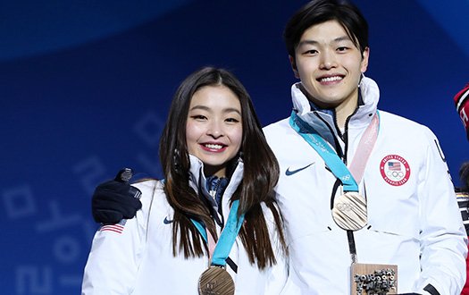 Maia and Alex Shibutani pose with their bronze medals on the medal stand.