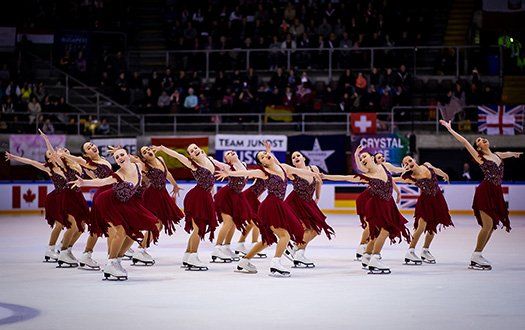 The Skyliners, wearing red, perform an element at the 2019 World Championships. 