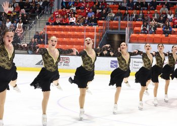 Dressed in black and yellow costumes, the Skyliners senior team shows its passion during a line element.