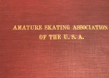 A red leather book cover with the words "Amature Skating Association of the U.S.A."