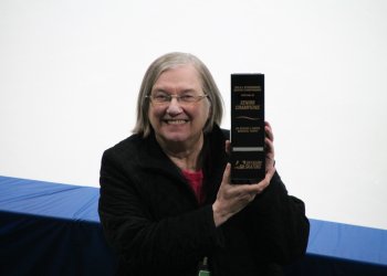 Synchro team manager Gail holds up a box.