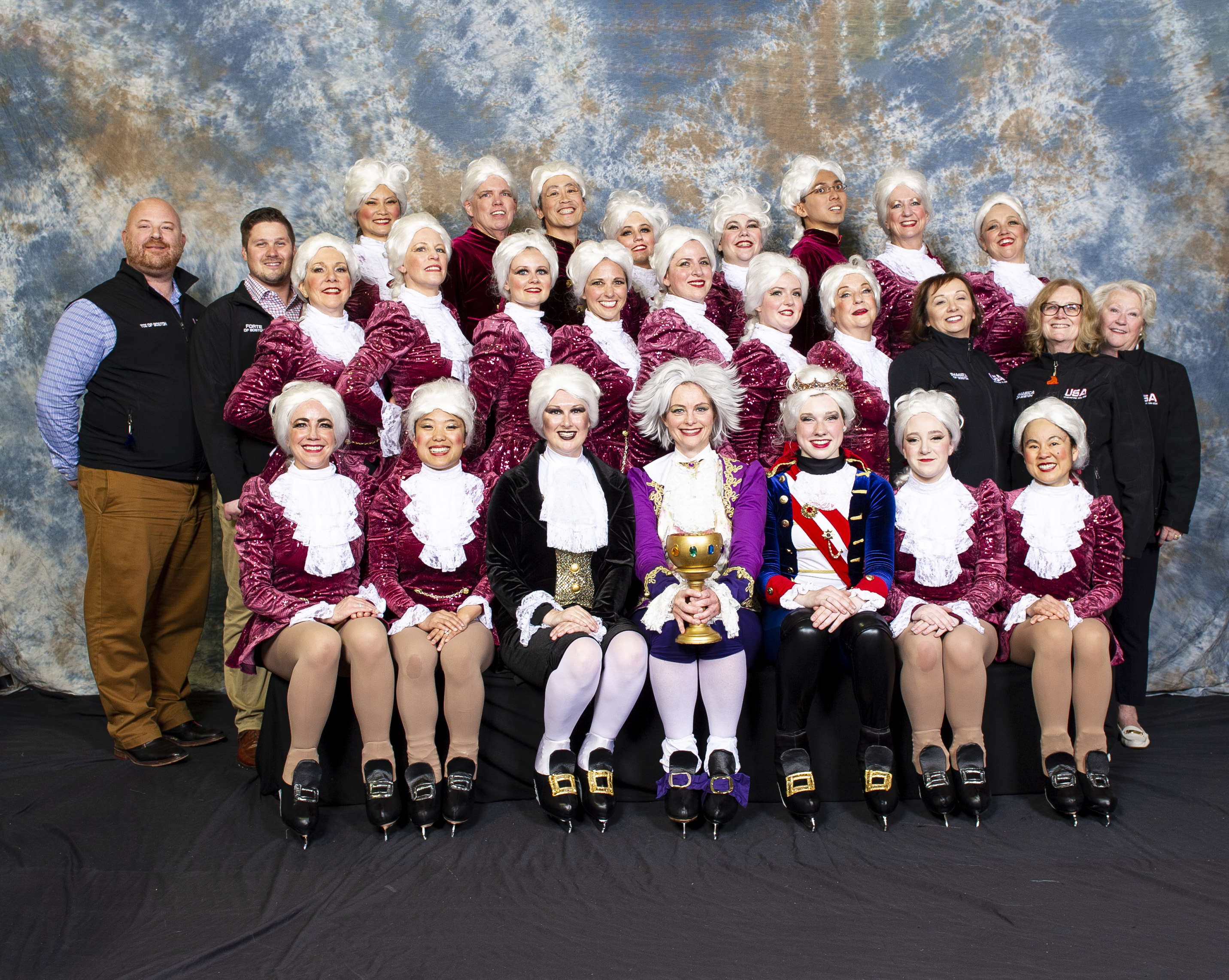 Imagica of Boston group photo dressed in 18th century jackets and white powdered wigs.