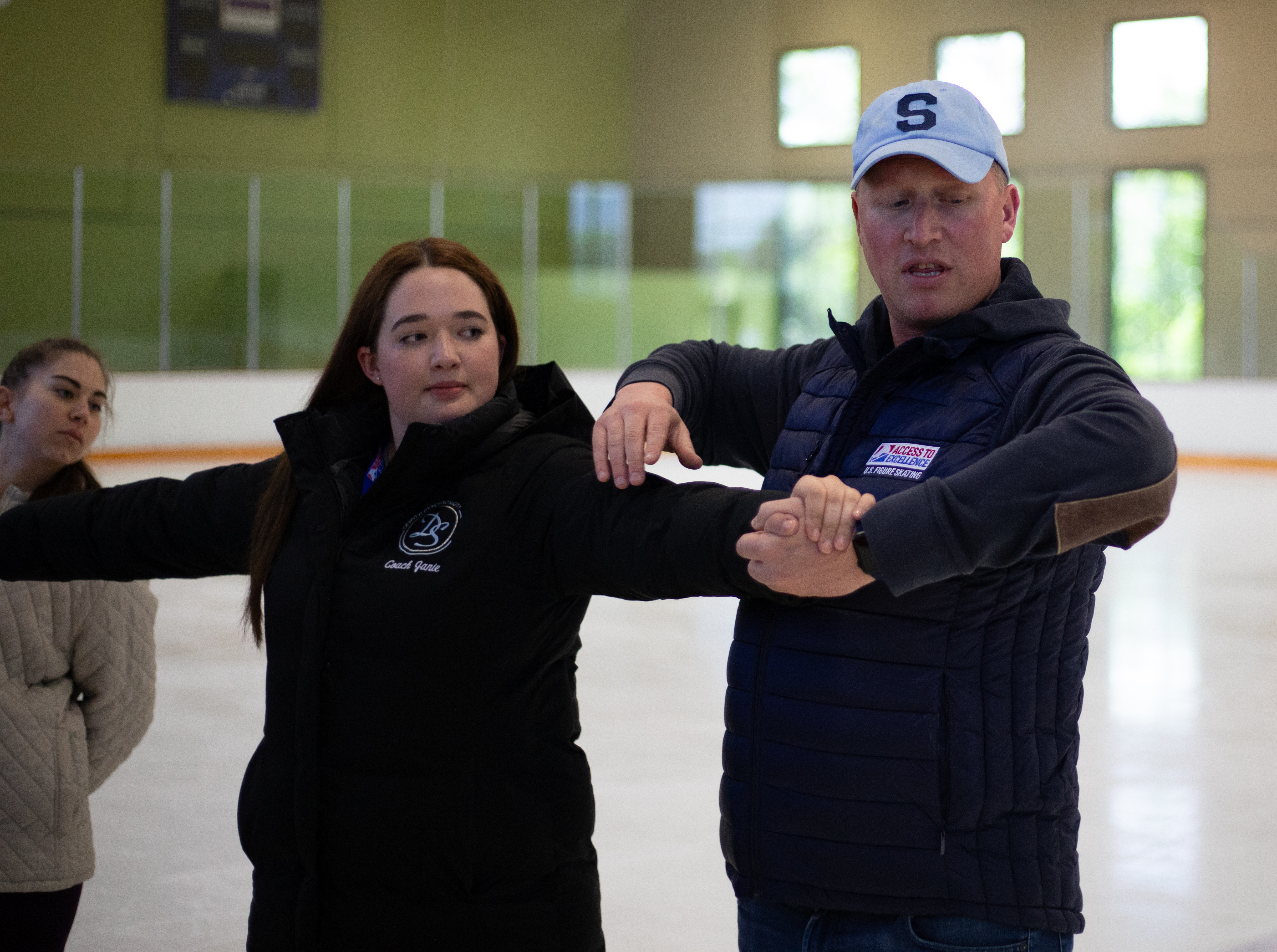 Synchronized skating coach Josh Babb demonstrates a proper hold.