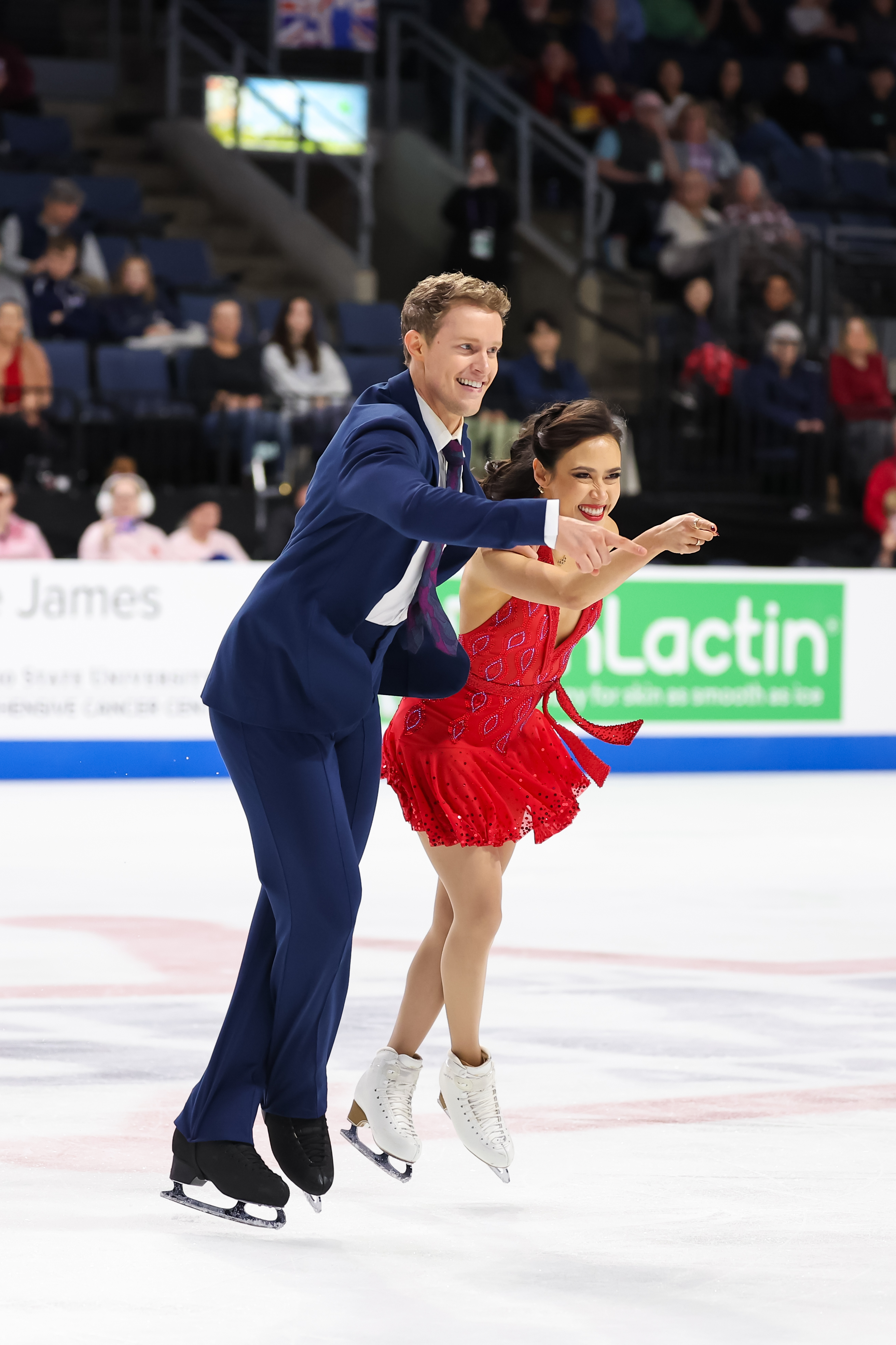 Madison Chock, dressed in red, and Evan Bates, dressed in a blue suit and tie, relive the moments from 1950s, 1960s and 1970s in their rhythm dance.