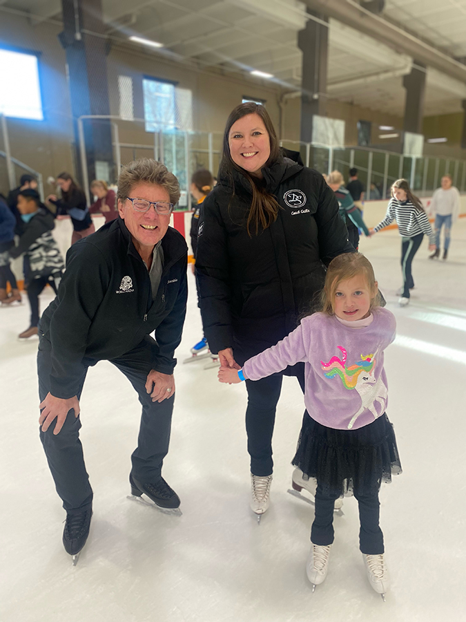 Two adults and a small child take part in World Ice Skating Day in Colorado Springs.