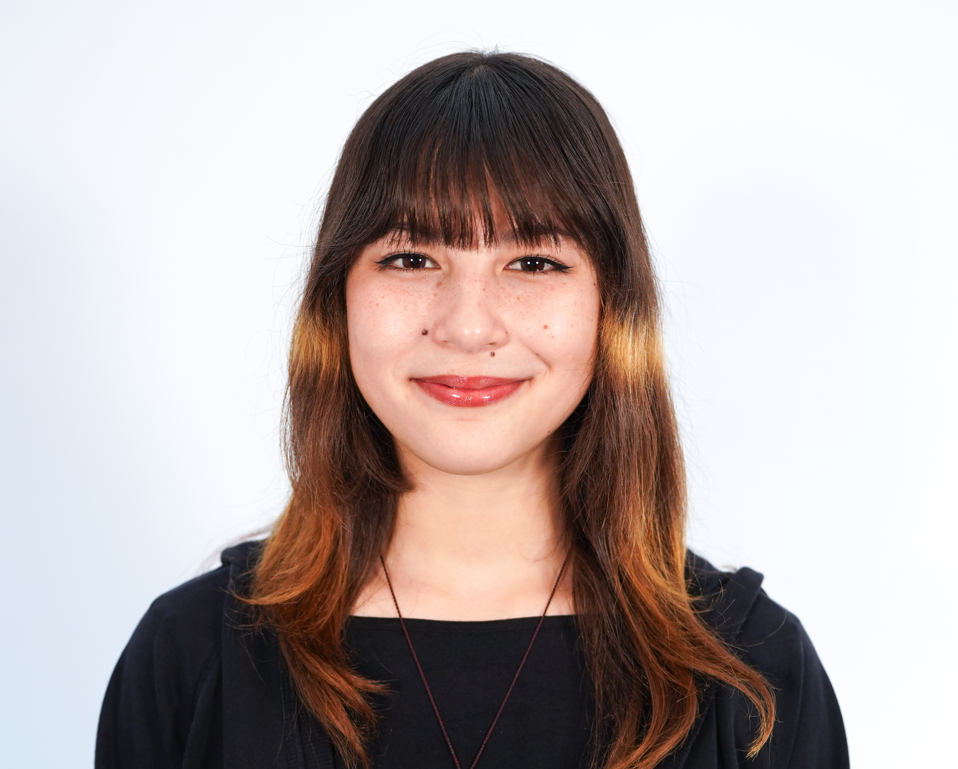 19-year-old Alysa Liu with a black shirt, bangs and shoulder-length hair.