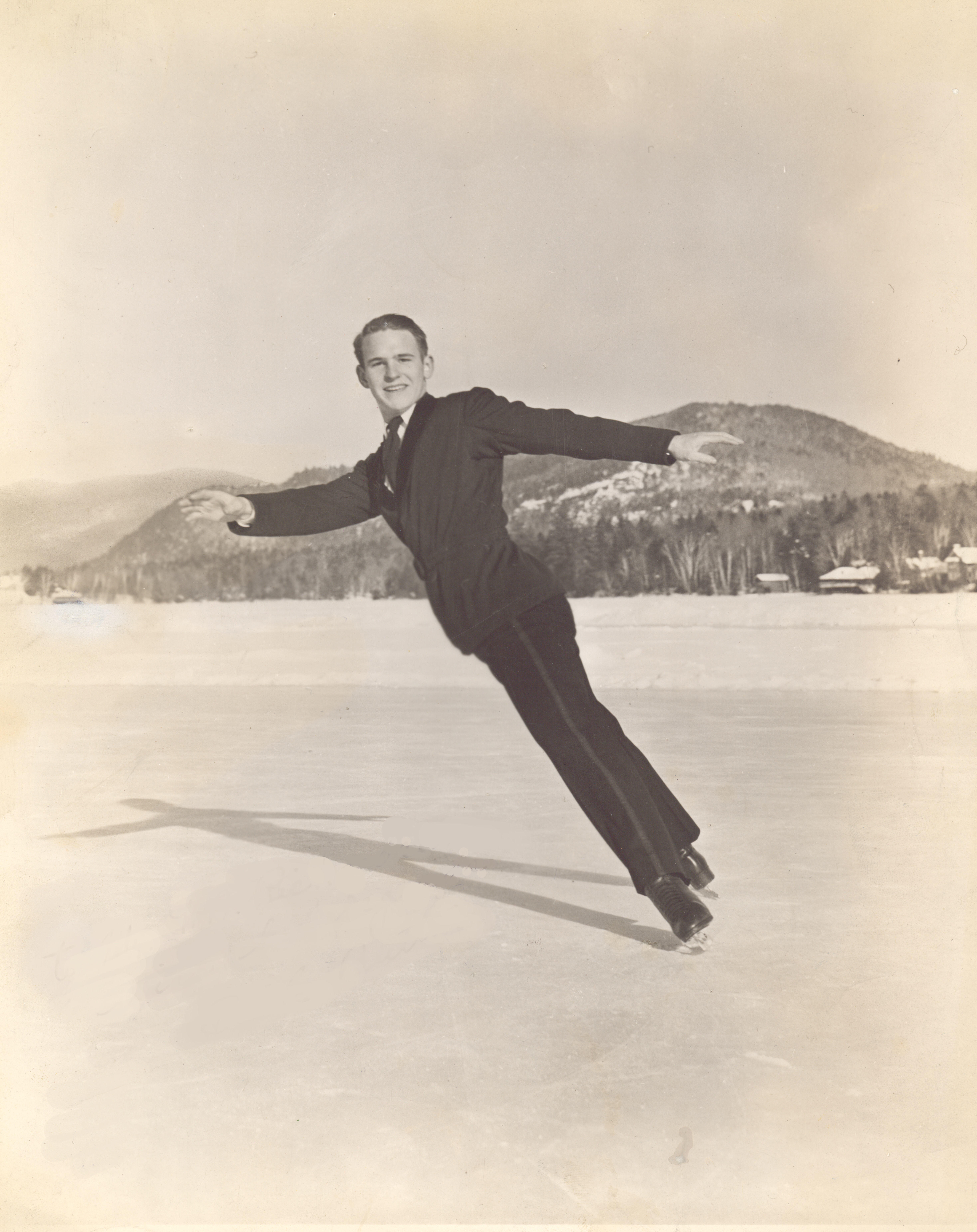 Dick Button performs an inside spread eagle on outdoor ice.