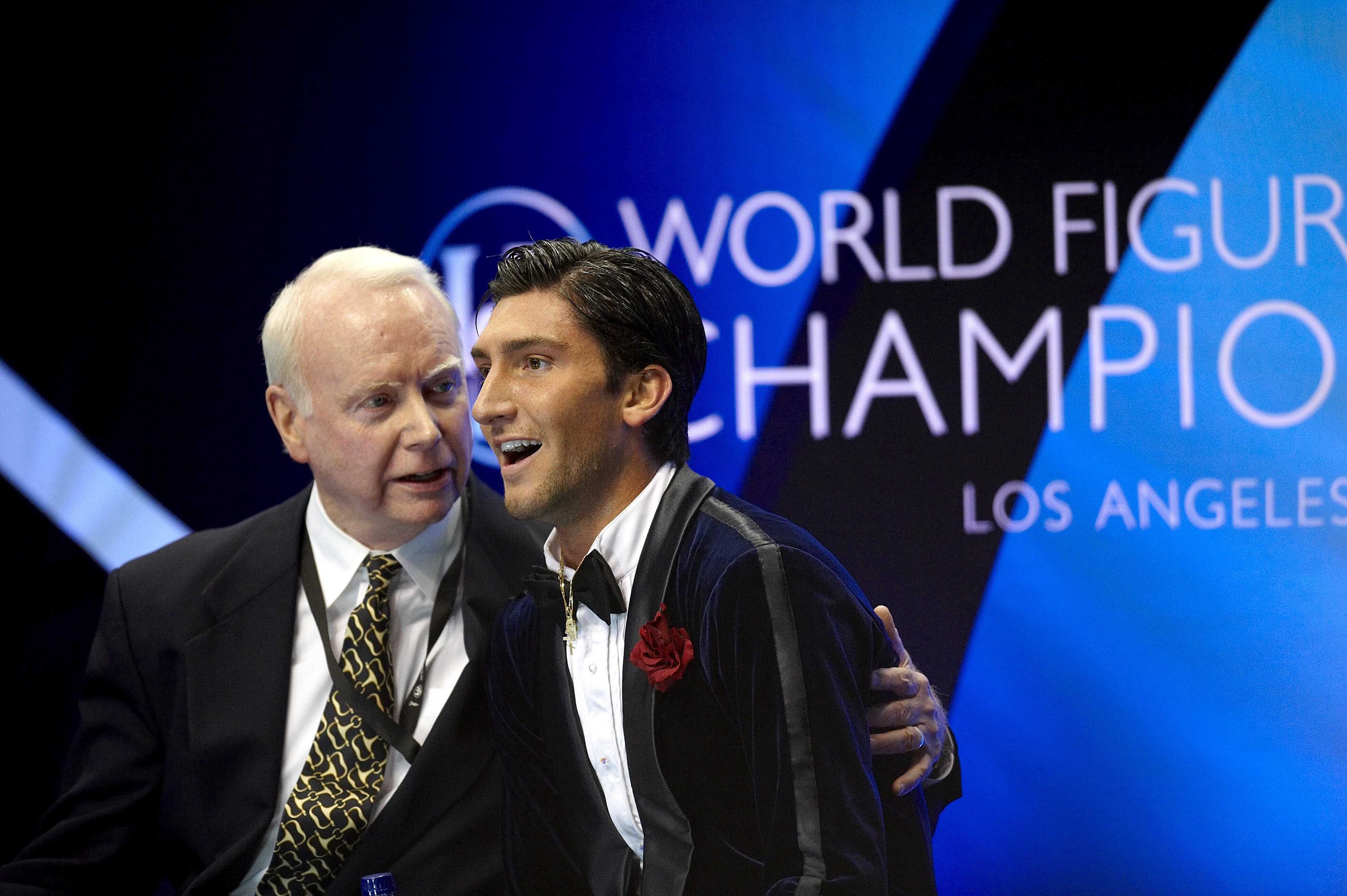 Evan Lysacek and coach sitting in the kiss and cry.