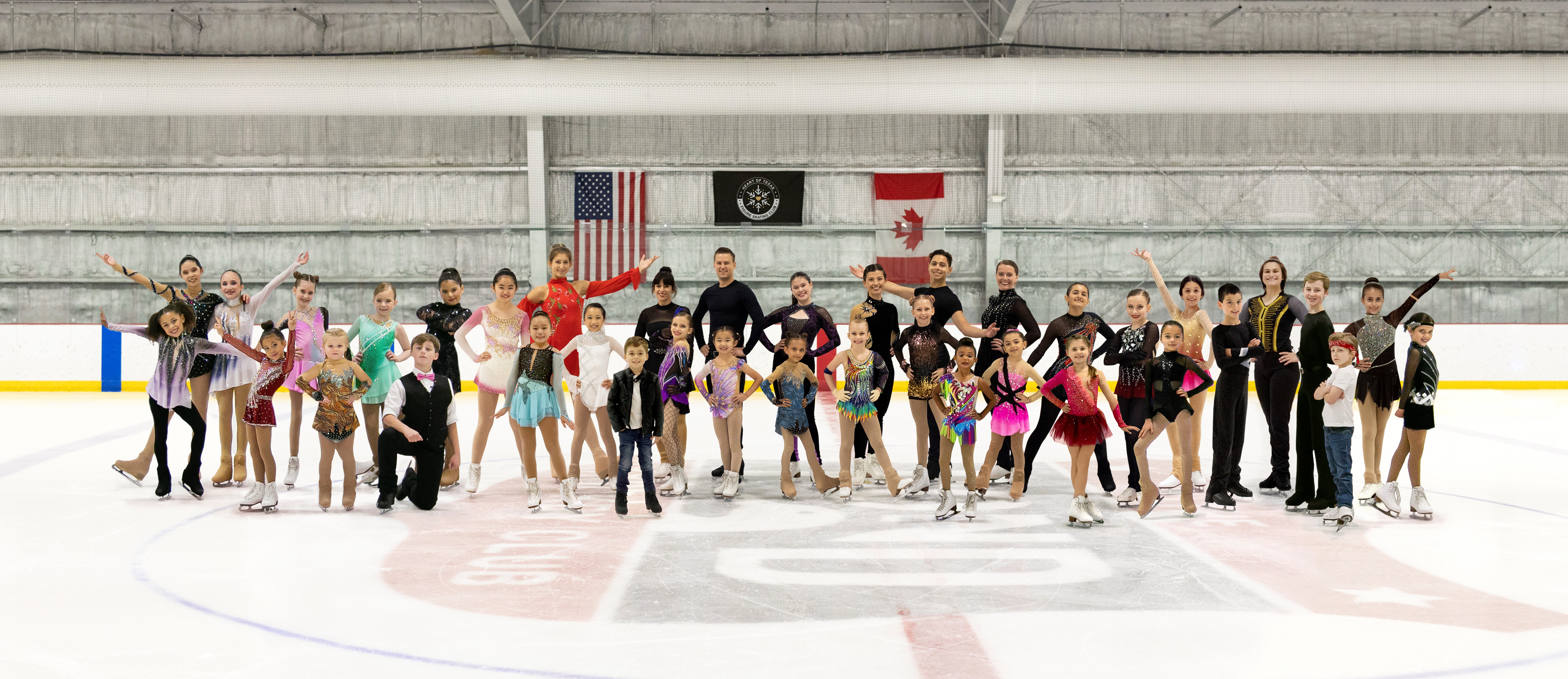 A group of skaters in costume pose in fun ways on the ice.