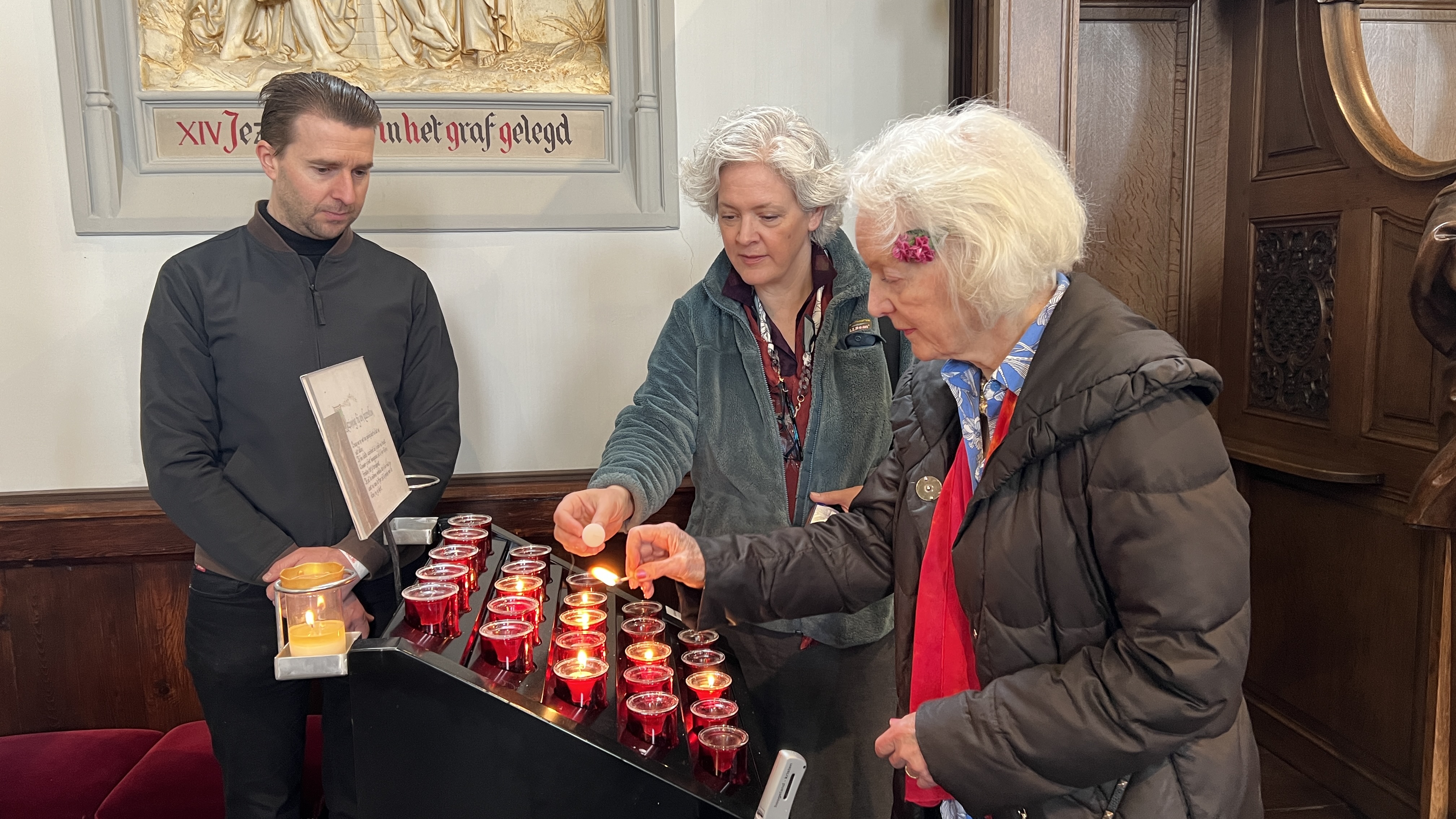 Albright and Gardiner light candles at the St. Servatjus Church. Its priest at the time, Father Joseph Cruyt, had rushed over to the scene to help first responders. 