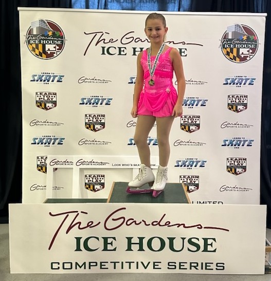 Skater in one of the rental suits stands on the podium 