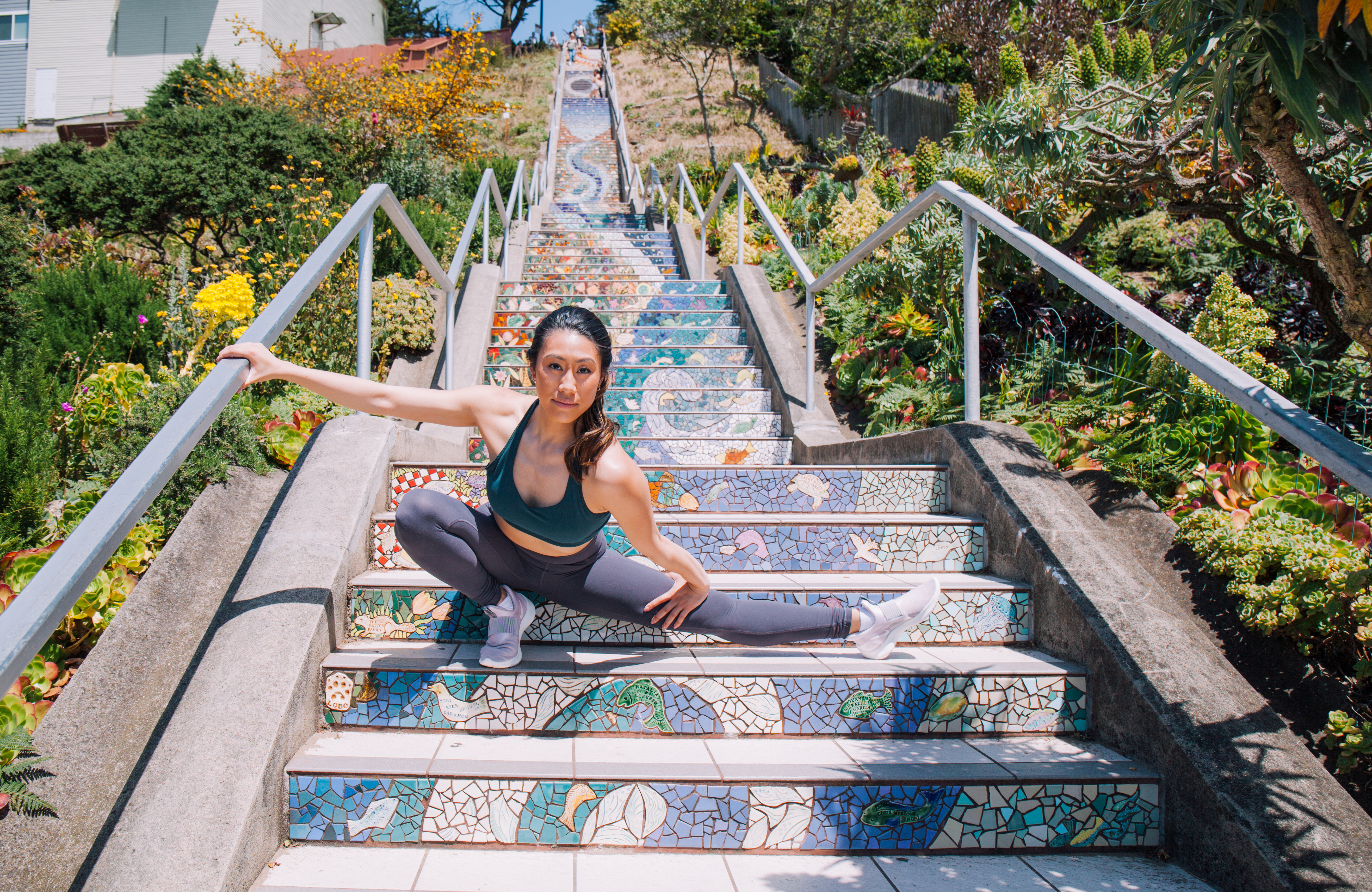 Michelle Hong demonstrates a side lunge on outdoor steps.