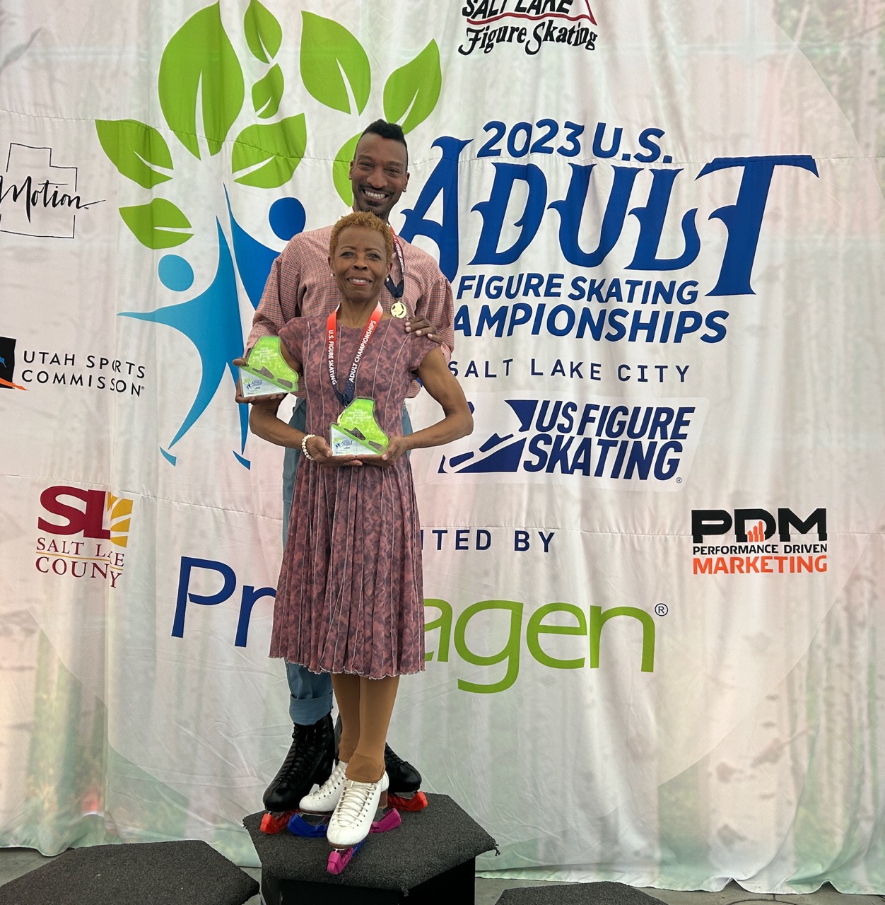 June Smith and Franklyn Singley stand on the podium at the 2023 U.S. Adult Figure Skating Championships presented by Prevagen.