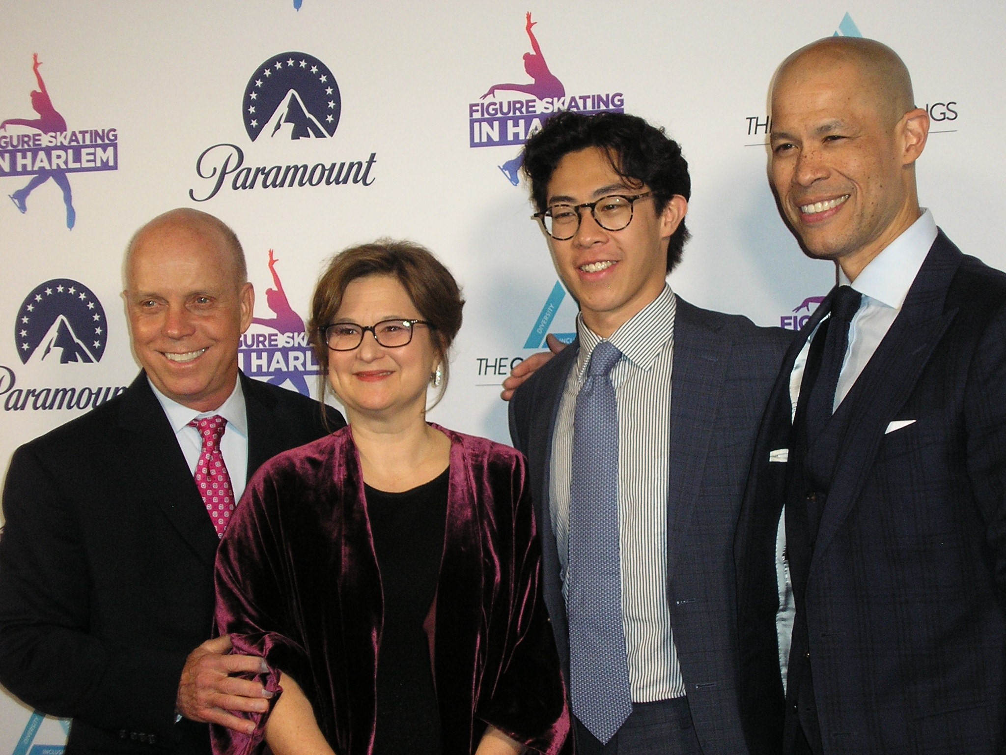 Scott Hamilton, Sharon Cohen, Nathan Chen and the evening's host, Vladimir Duthiers of CBS News post for a photo at Figure Skating in Harlem's gala.