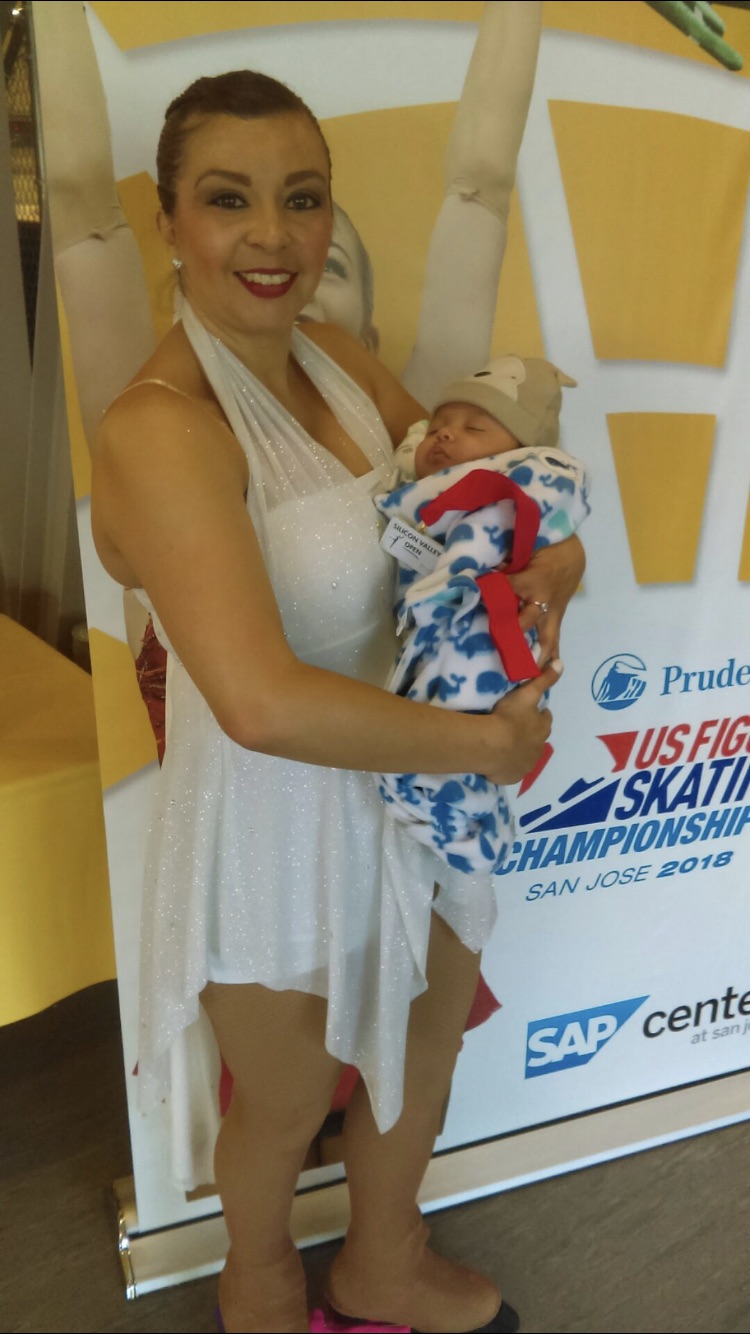 Rachel Duran poses with her 3-year-old son after a skating competition.