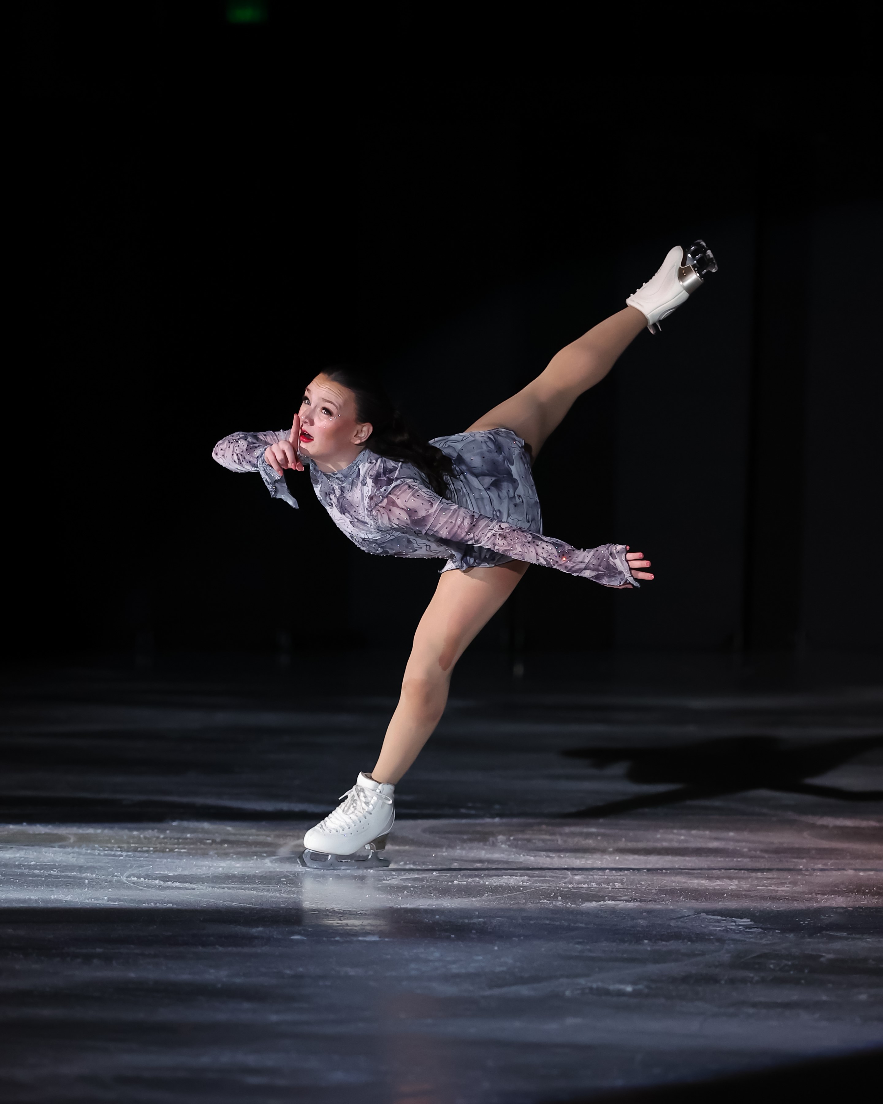 Mia Rocca performs a spiral while giving a whisper sign.