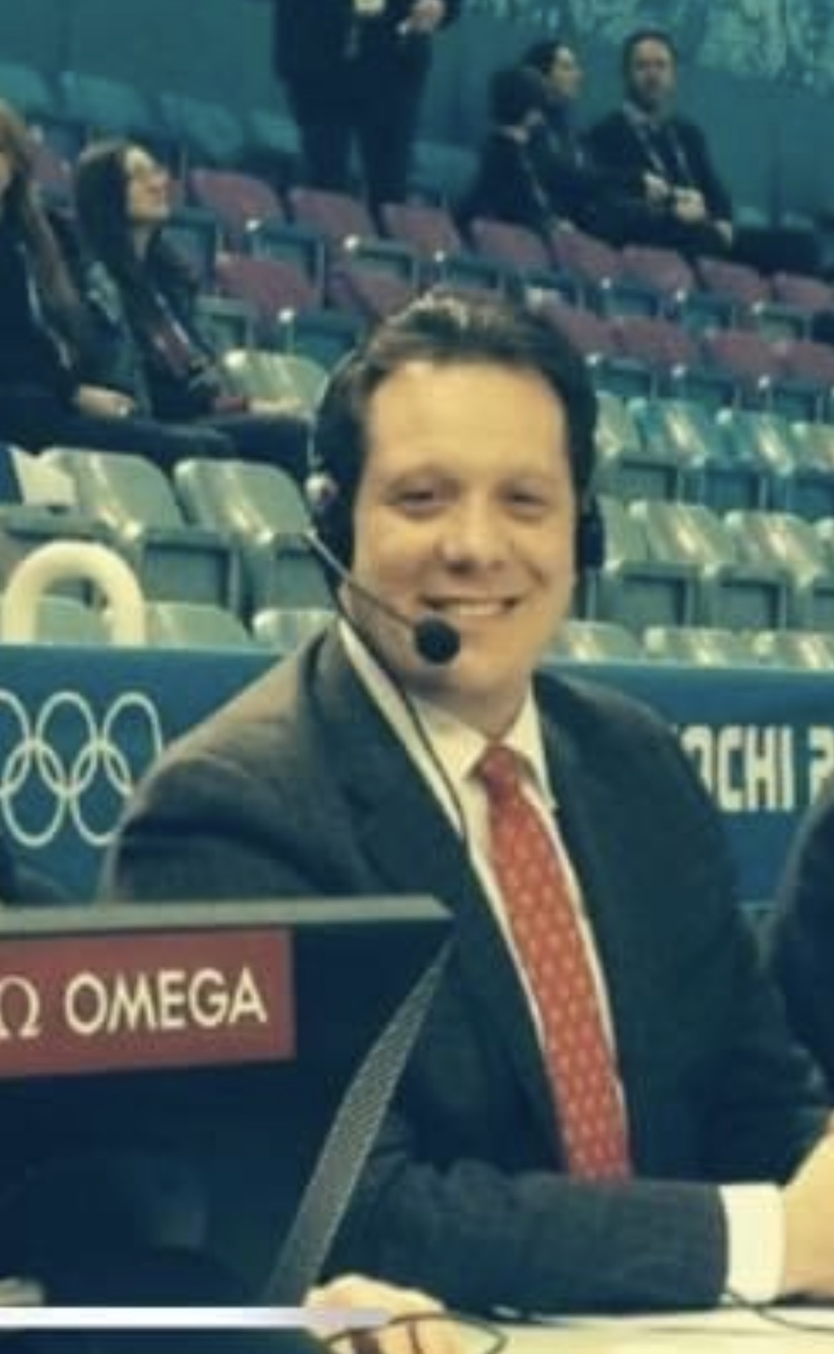 Troy Goldstein wearing a headset at the judges table of a competition.