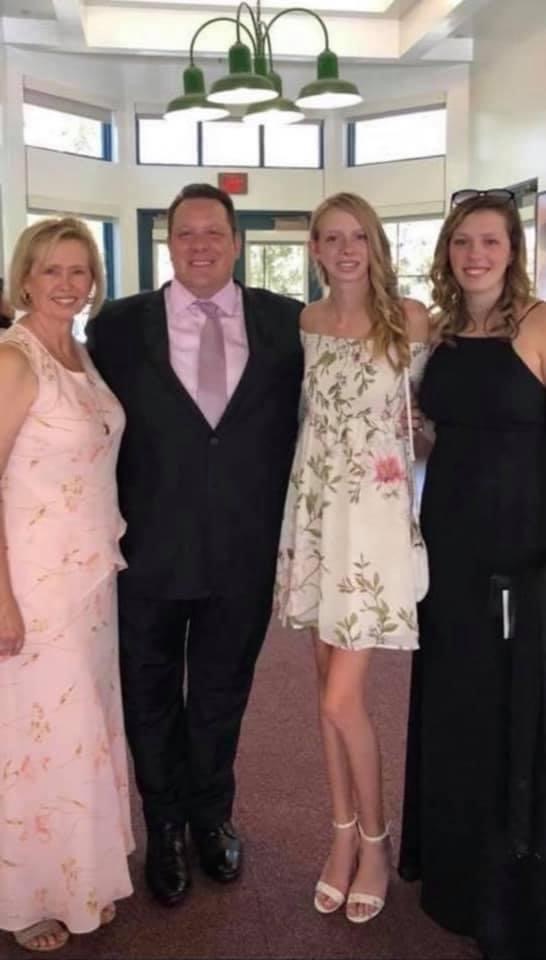 Troy Goldstein and his family of two daughters and wife in evening gowns.