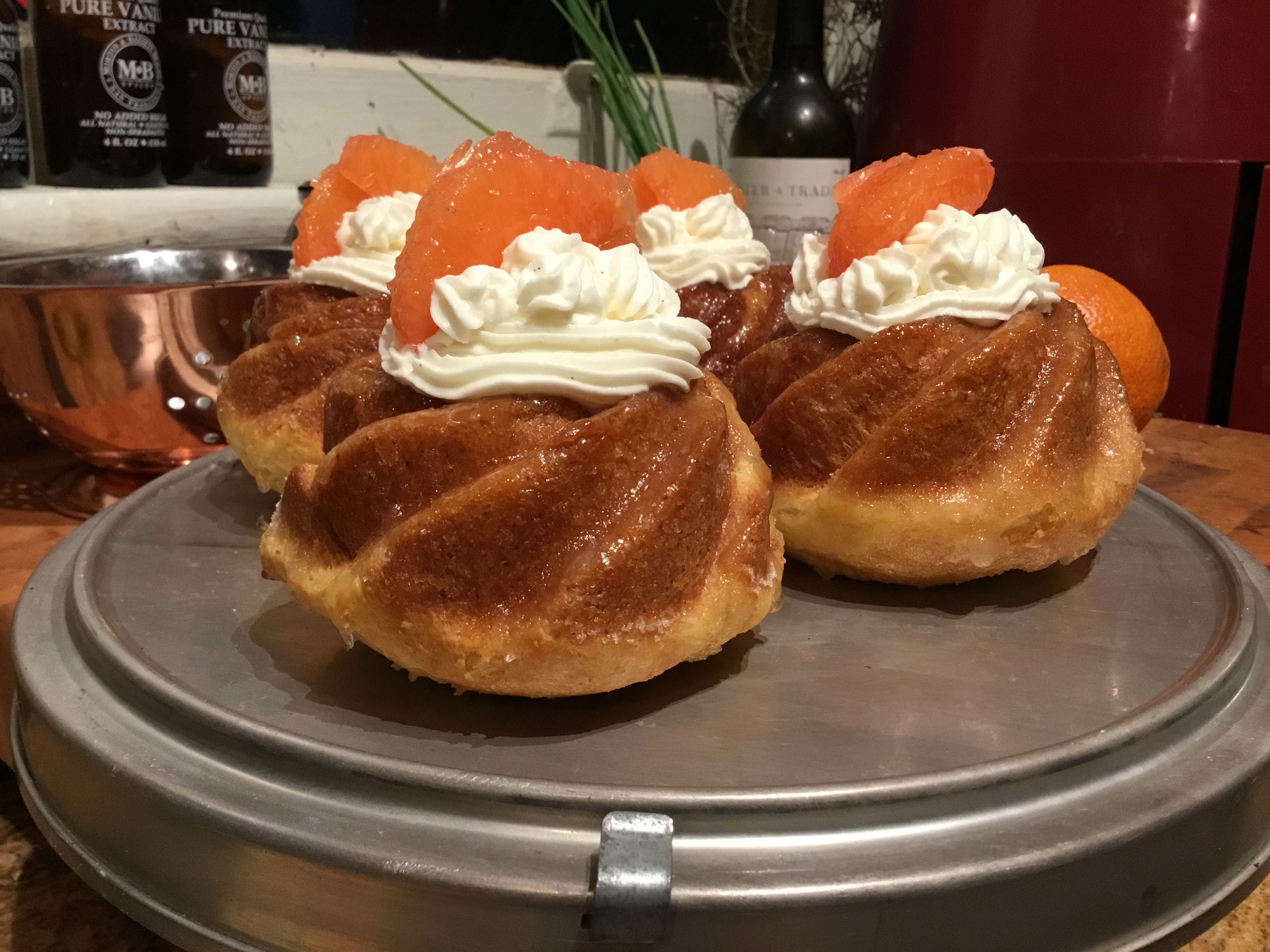 Rum Babas pastries with cream dolloped on top.