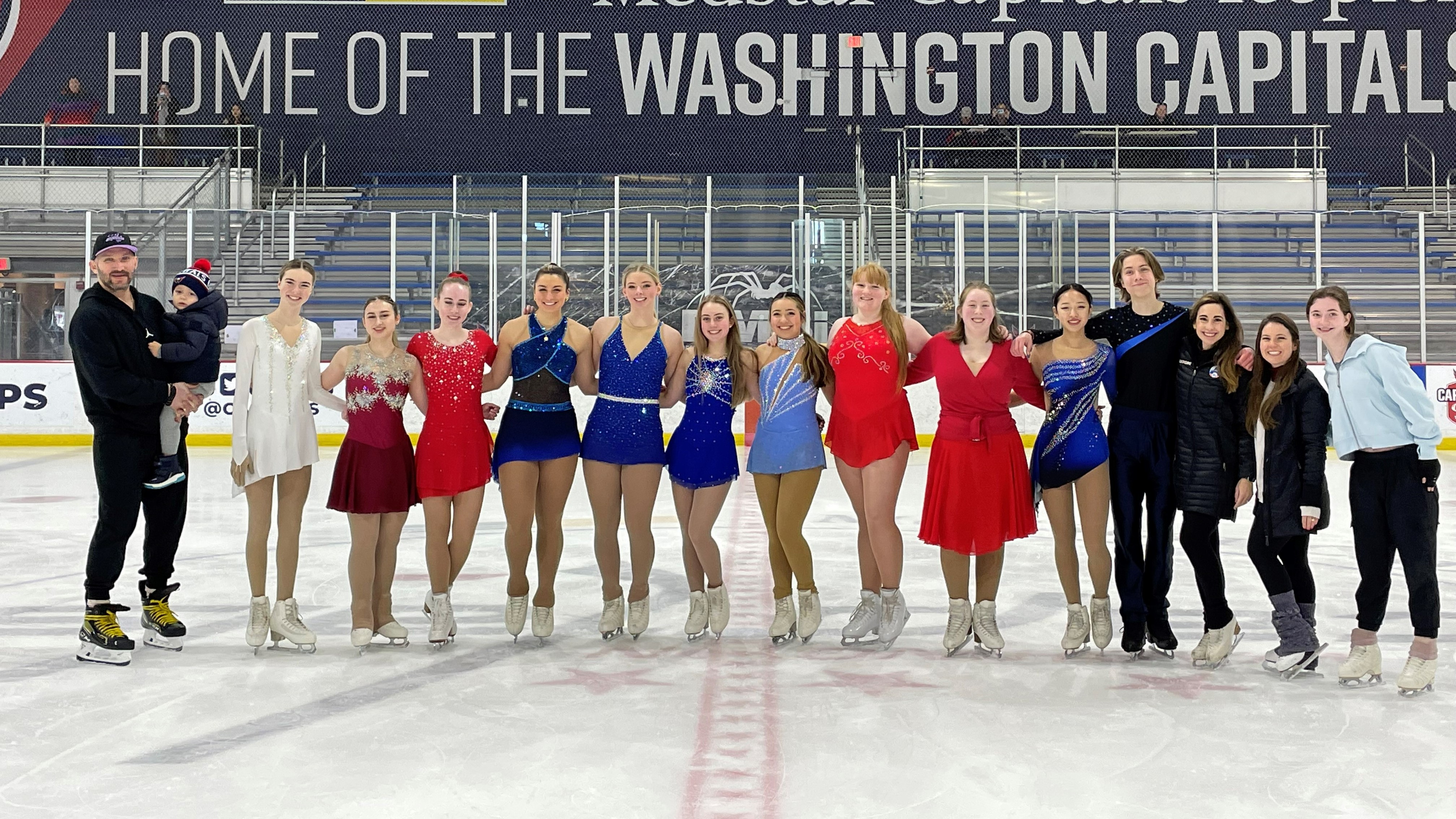 Alex Ovechkin poses for a photo on the ice with the Capitol High School Figure Skating Team