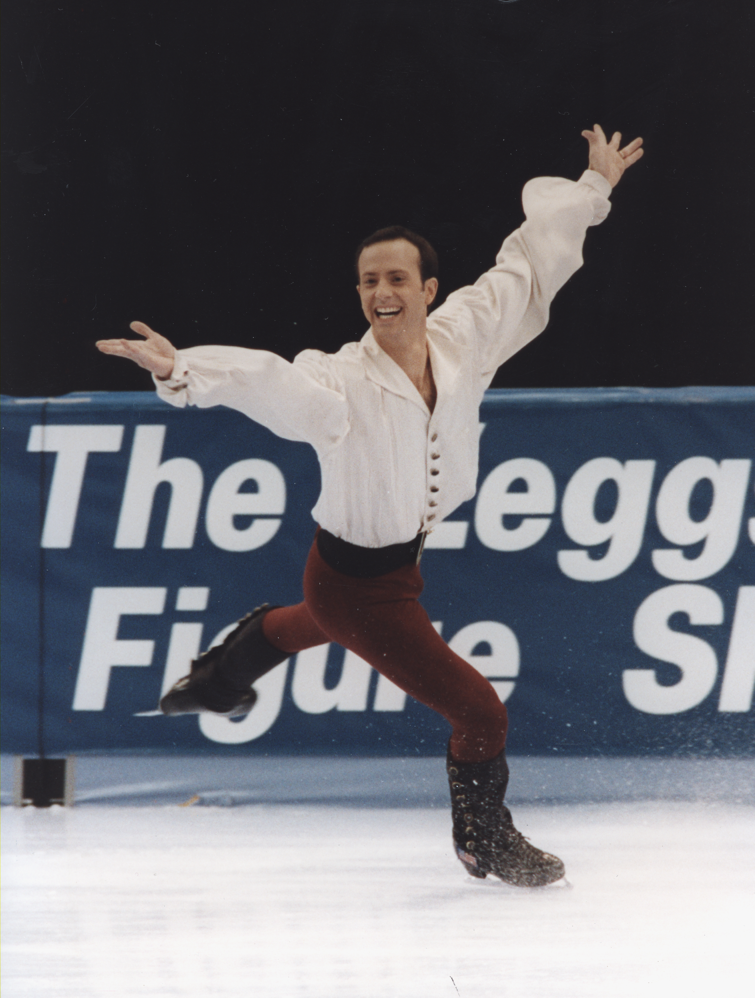 Brian Boitano skating in a flowy white shirt.