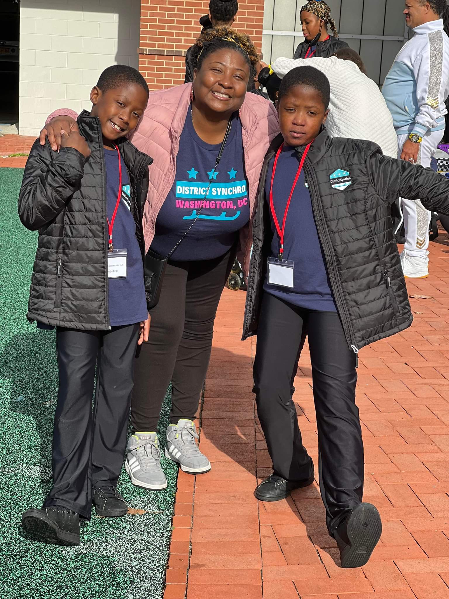 Sheldonna Harris poses with her two sons while wearing a District Synchro tshirt