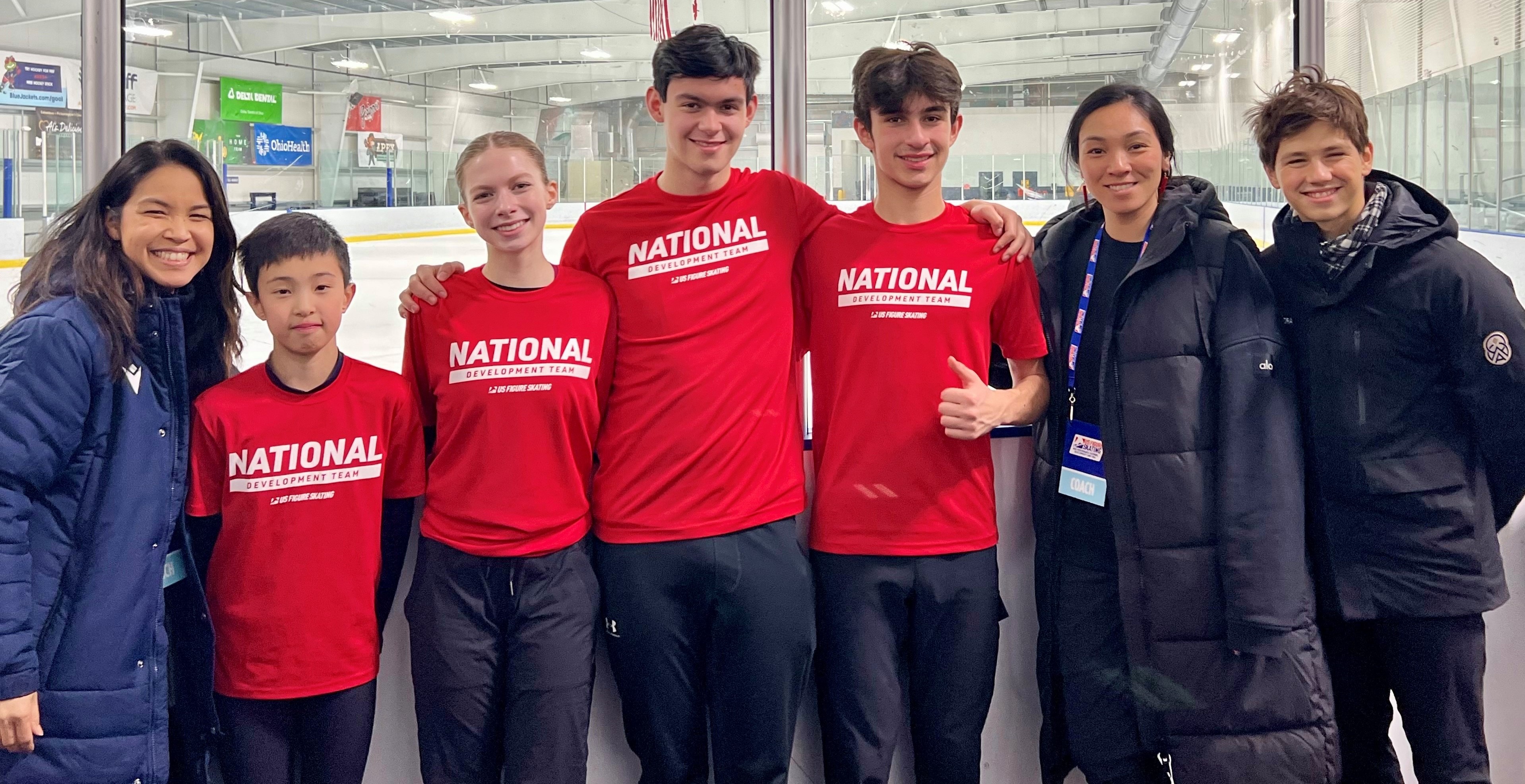 Nani and Mari stand with a group of athletes wearing red National Development tshirts