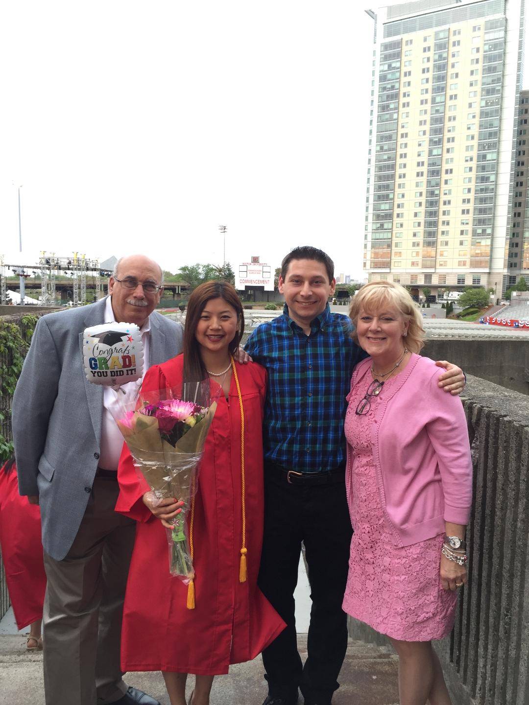 Eliana Roth in graduation garb next to her family.