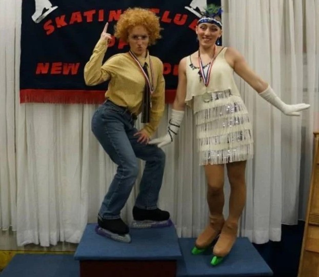 Violet Scibior stands on top of the podium dressed as Napoleon Dynamite