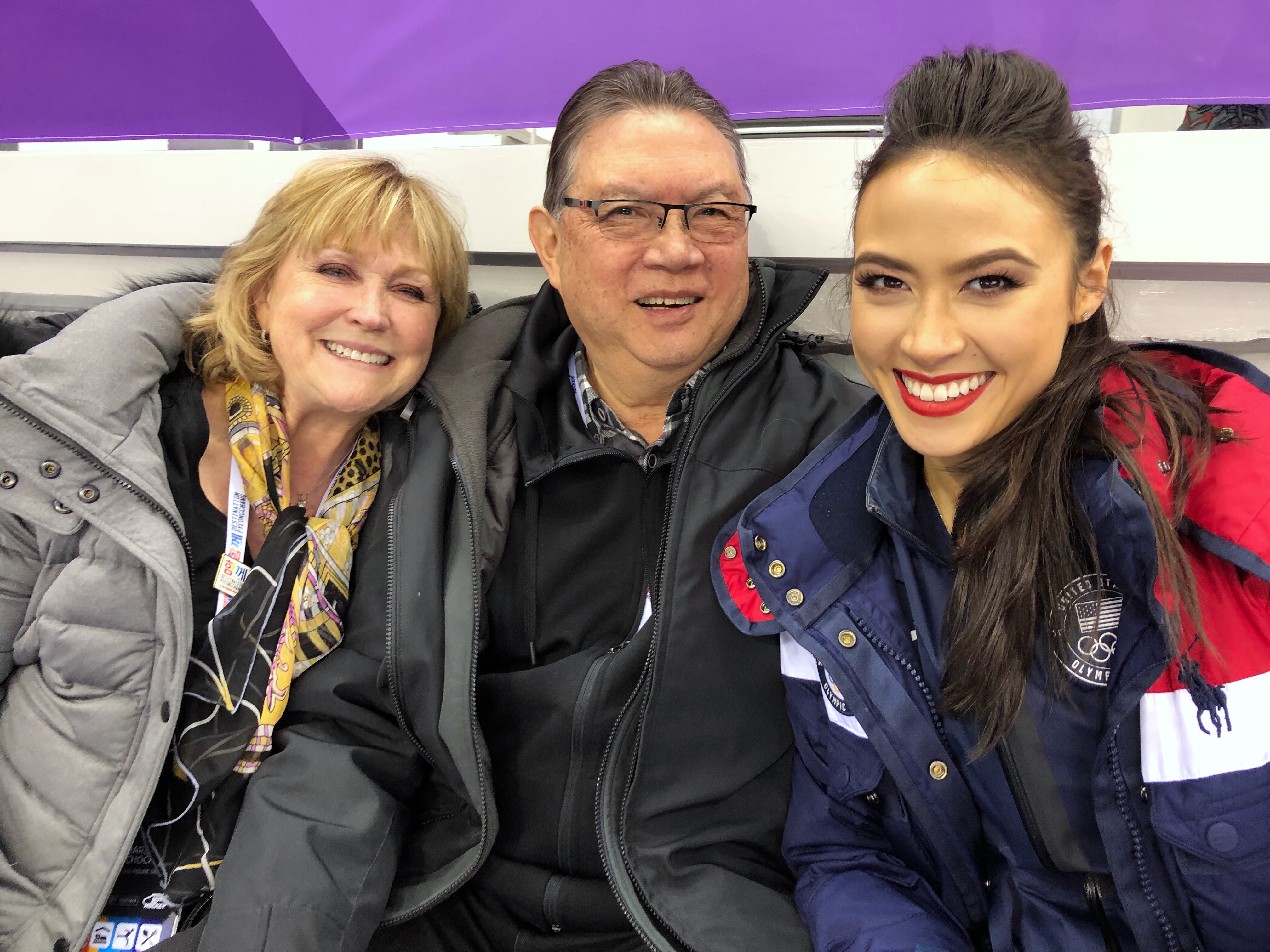 Madison Chock smiles for the camera with her mother and father seated to her right. 