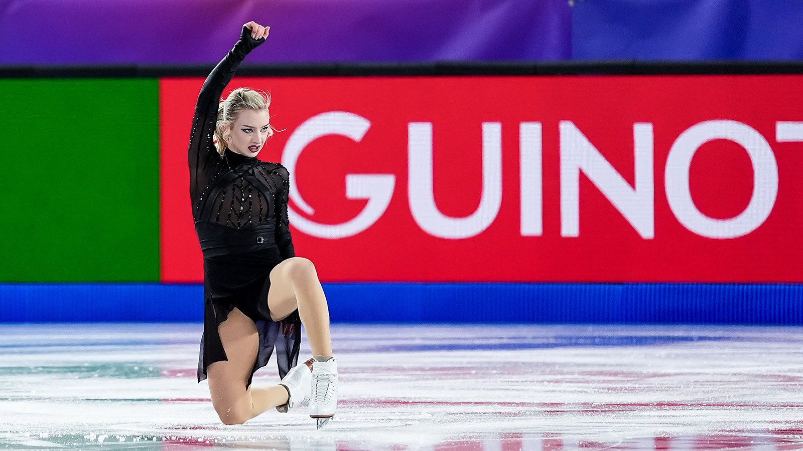 Wearing all black, down on one knee, one arm extended, Amber Glenn shows deep conviction at the Grand Prix Final