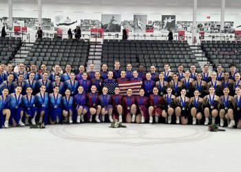 All three U.S. teams that medaled at the 2025 U.S. Synchronized Skating International Classic pose for a photo together on the ice at The Skating Club of Boston. On the left, in blue dresses with sparkly blue tops and wearing the junior bronze medal is Skyliners junior. The Haydenettes are in the center, wearing bronze medals and costumes that are different shades of purple and red. On the right is Teams Elite, which won gold in the junior competition. They wear black dresses with jewels on the top.