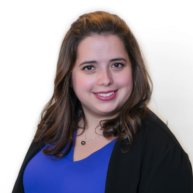 Headshot of Rachael Naphtal. She is a woman with shoulder length brown hair wearing a blue top with a black sweater