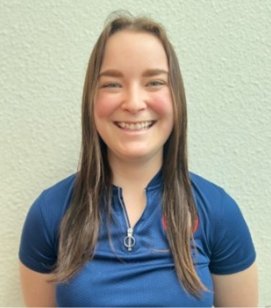 Headshot of Tara Card. Tara is a young white woman with long brown hair. She is wearing a blue collared shirt and smiling. 