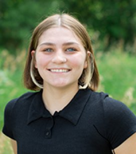 Headshot of Sara Arnold. She is a woman with short brown hair wearing a plain black tshirt